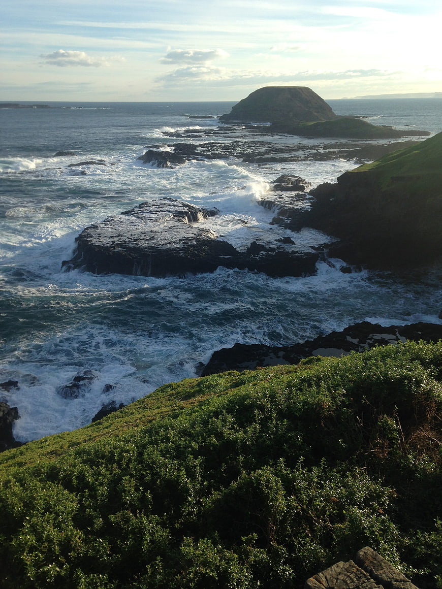 Dramatic coastal landscape with crashing waves and rocky island