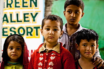 Portrait of Four Children in India with Resort Sign