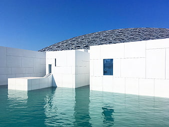 Modern white architecture with dome and pool
