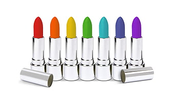 Rainbow colored lipsticks in silver tubes on white background