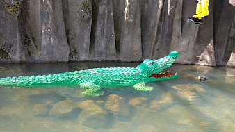 Green Lego Crocodile Sculpture Floating in Water
