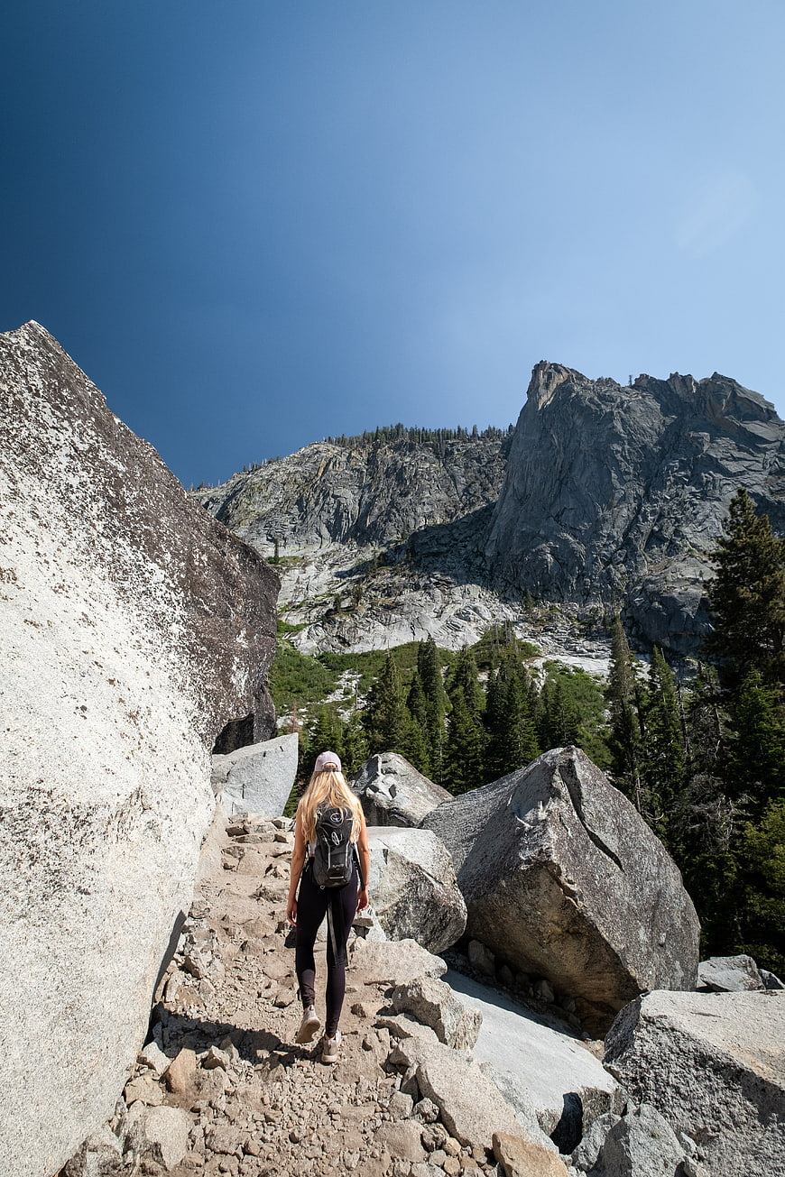 Woman Hiking on Rocky Mountain Trail with Backpack