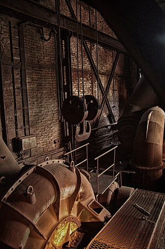 Rusty industrial machinery in abandoned factory interior