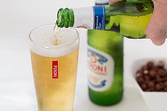Pouring Peroni Nastro Azzurro Beer into Glass