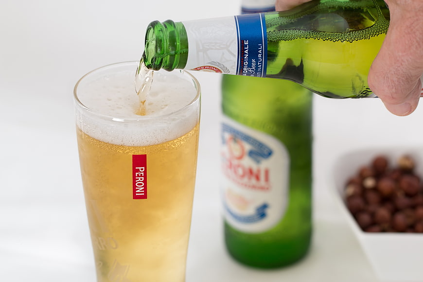 Pouring Peroni Nastro Azzurro Beer into Glass