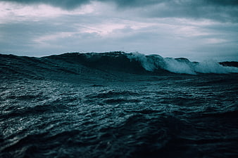 Dramatic Dark Ocean Wave Under Stormy Sky