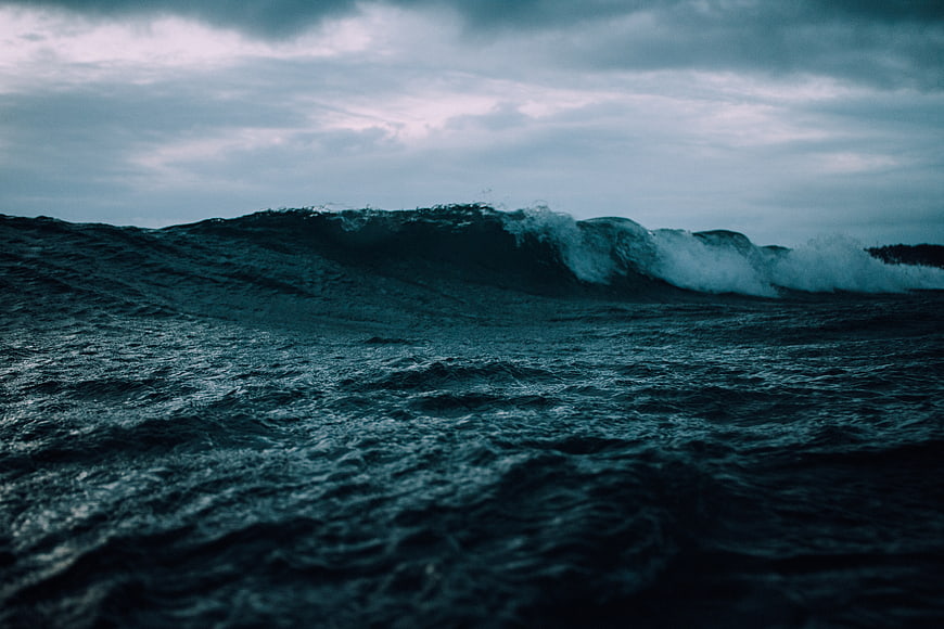 Dramatic Dark Ocean Wave Under Stormy Sky