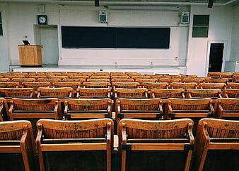 Empty Lecture Hall with Wooden Chairs and Blackboard