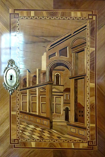 Ornate wooden marquetry inlay with architectural scene and keyhole