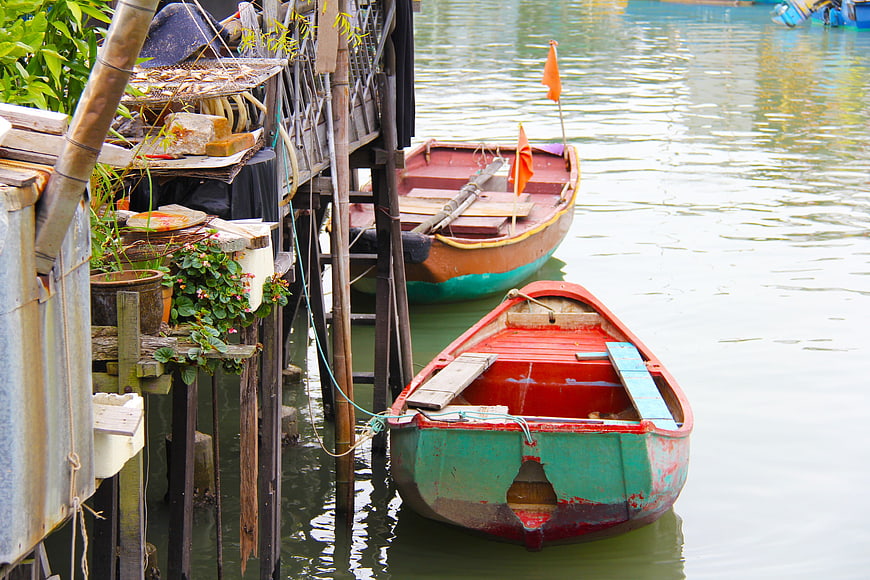 Traditional Colorful Wooden Boats Docked at Waterfront Village