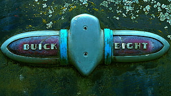 Vintage Buick Eight Emblem on Weathered Car Hood