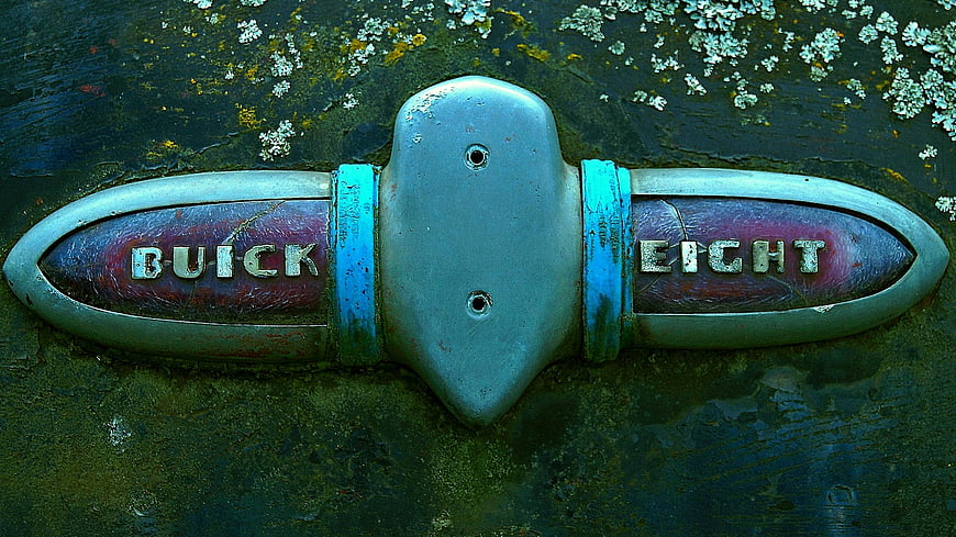 Vintage Buick Eight Emblem on Weathered Car Hood