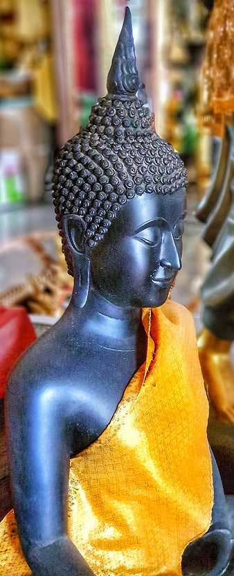 Close-up of Black Buddha Statue with Golden Robe