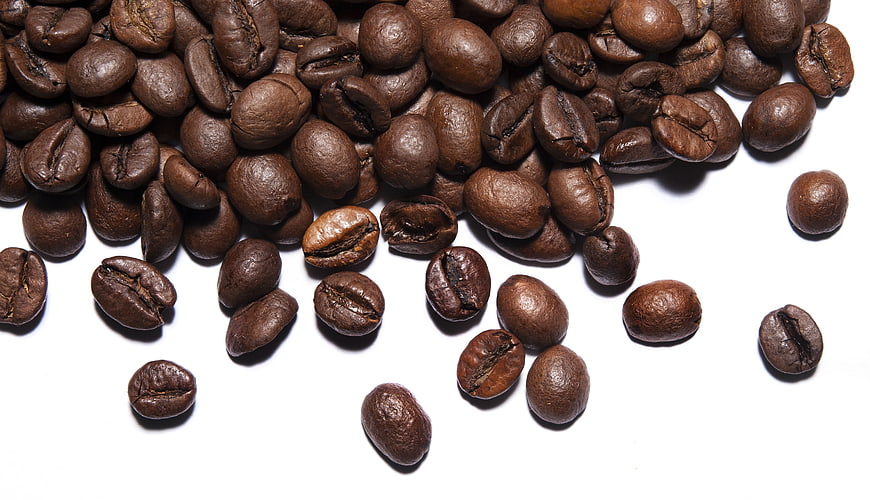 Roasted Coffee Beans Scattered On White Background