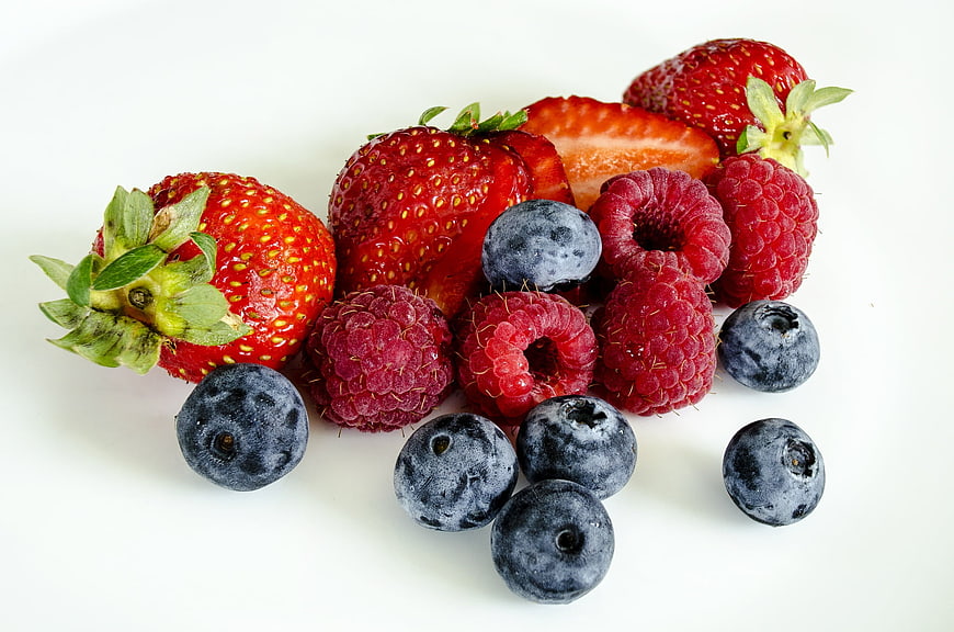 Fresh mixed berries on white background