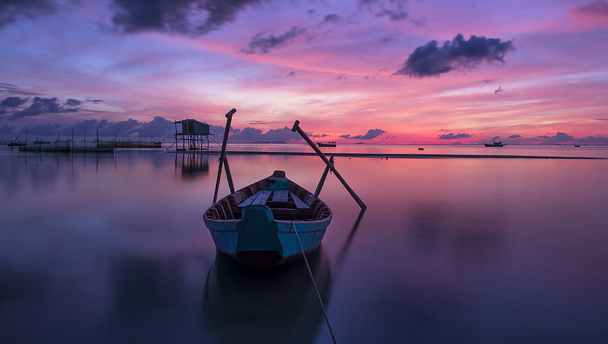 Traditional Fishing Boat at Vibrant Sunset