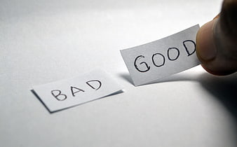 Hand choosing good over bad paper note