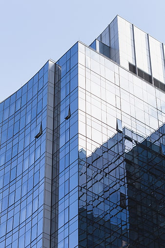 Modern Glass Skyscraper Architecture with Blue Sky Reflection