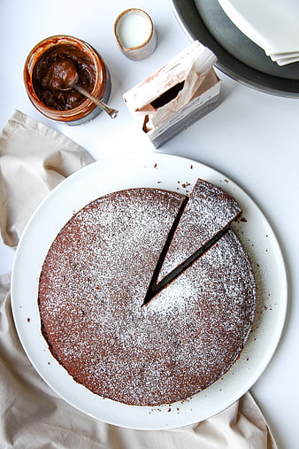 Top View of Chocolate Cake with Powdered Sugar and Ingredients