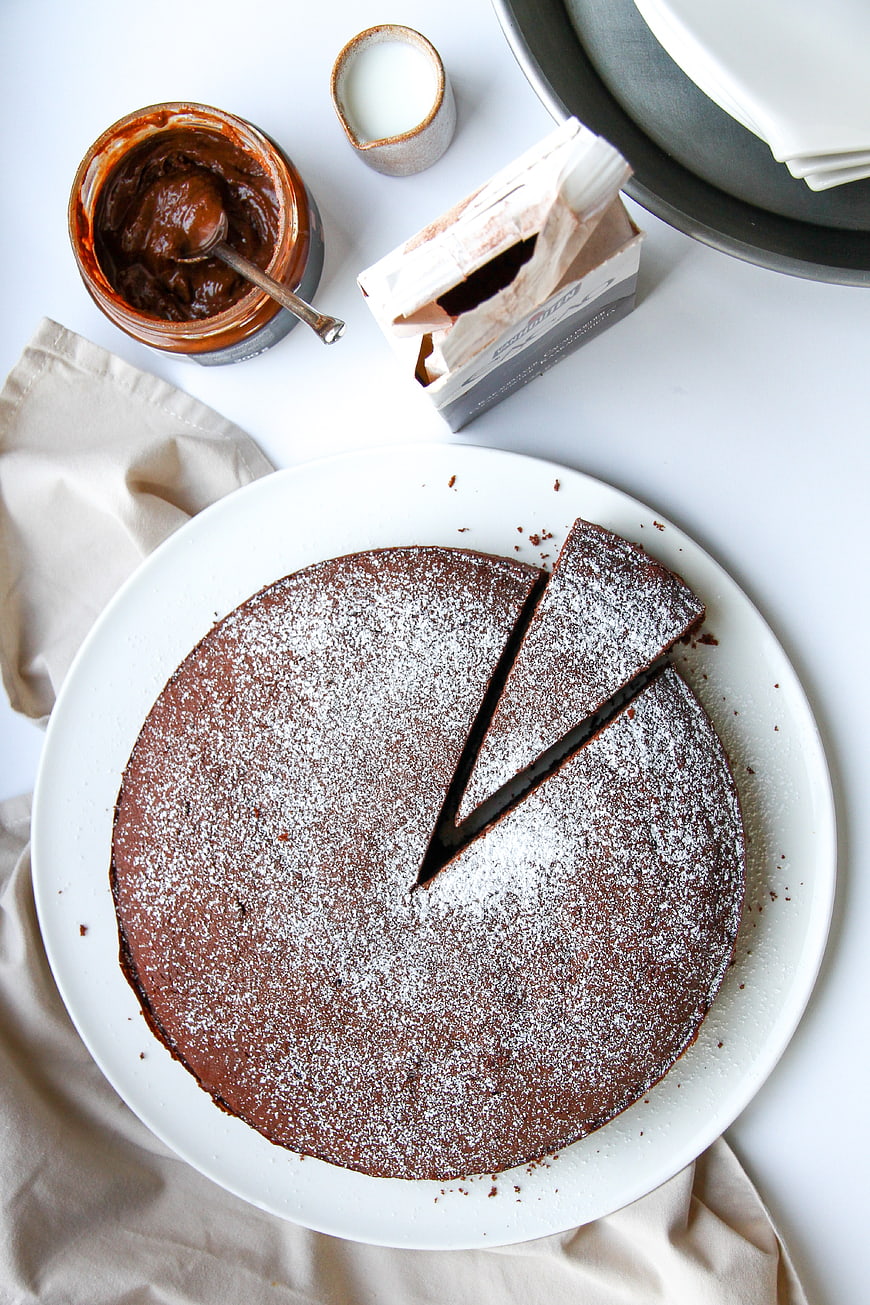 Top View of Chocolate Cake with Powdered Sugar and Ingredients