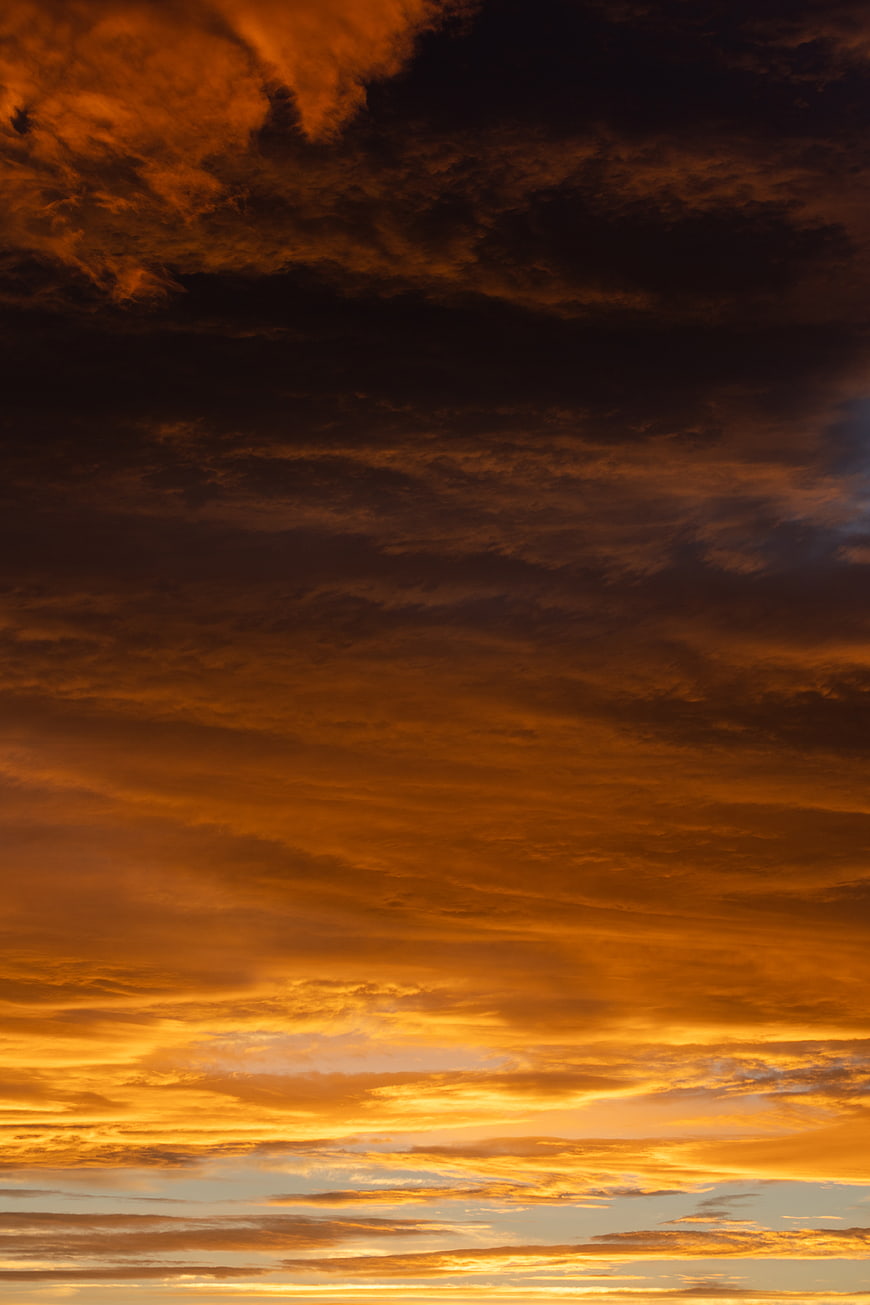 Dramatic fiery orange sunset clouds in the sky