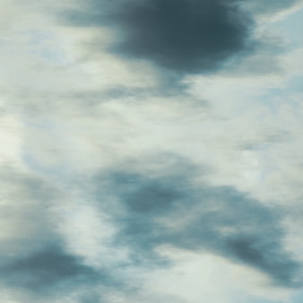 Soft Blue Sky With Fluffy White Clouds And Dark Stormy Patches