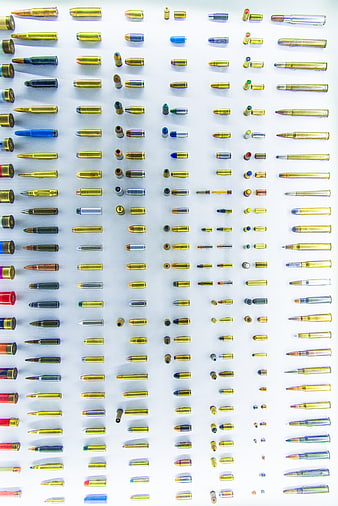 Flat lay of various ammunition cartridges on white background