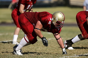 American Football Player in Red Uniform Ready Stance