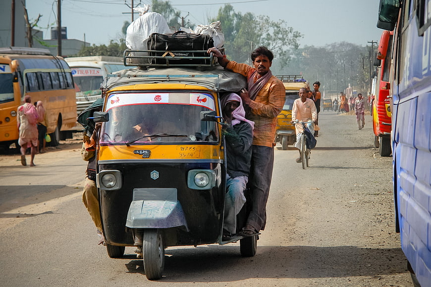 Overloaded Auto Rickshaw on Busy Indian Road