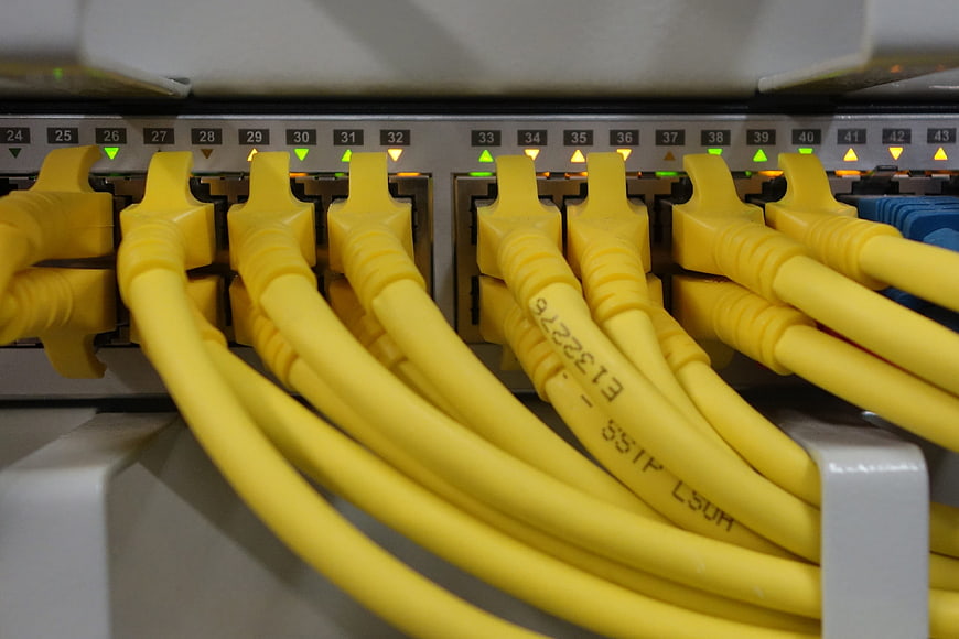 Close-up of yellow ethernet cables connected to network switch