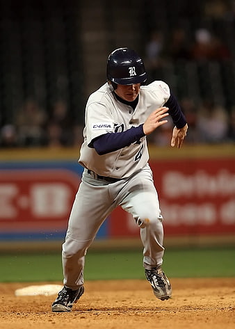 Baseball Player Running on Dirt Field at Night