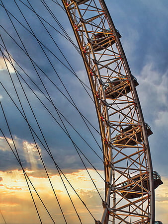 Ferris Wheel Structure Against Dramatic Sunset Sky