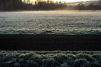 Frosty Winter Field with Dark Path at Sunrise