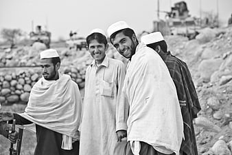 Afghan Men in Traditional Clothing Smiling in Black and White