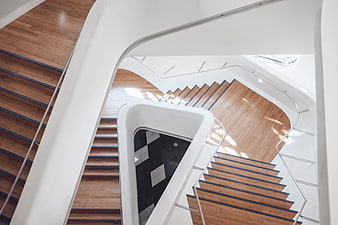 Modern Spiral Staircase with Wooden Steps and White Walls