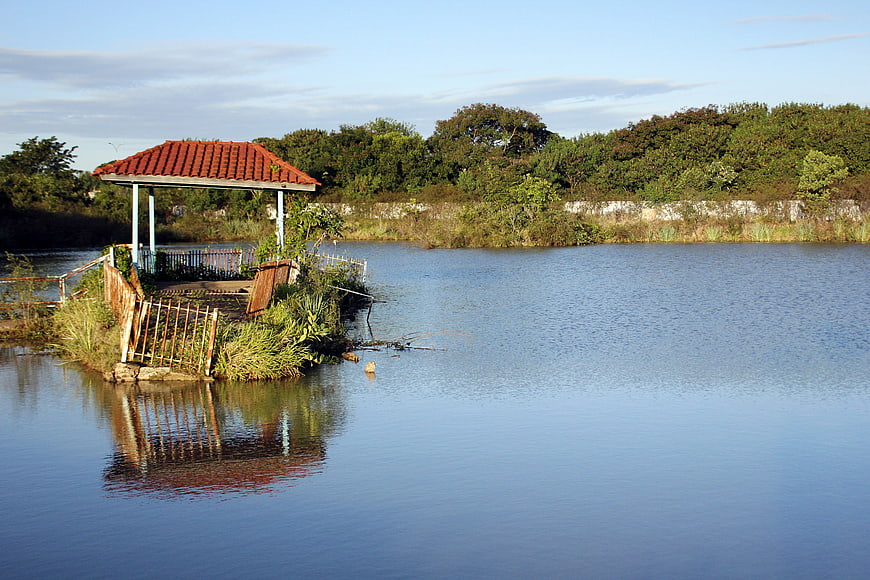 Serene Lake with Red-Tiled Gazebo and Reflection