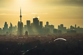 City skyline silhouette at golden hour with atmospheric haze