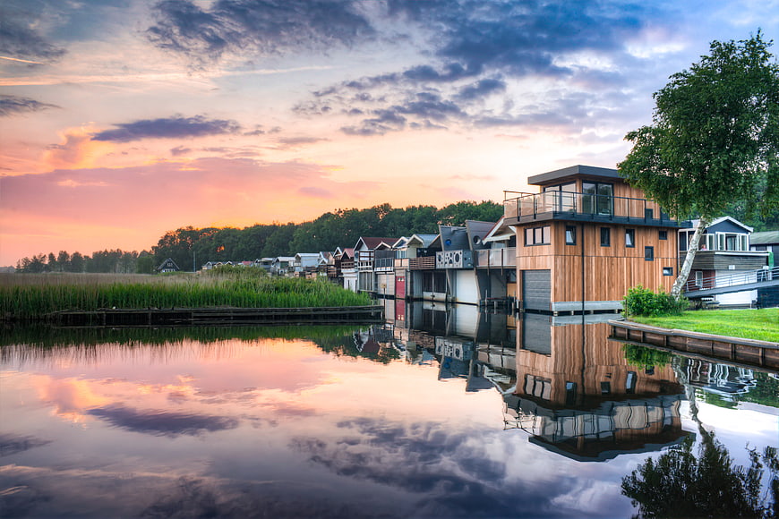 Colorful Houseboats on Lake at Sunset with Reflection