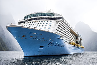 Ovation of the Seas cruise ship sailing in a misty fjord