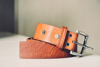 Brown Leather Belt with Silver Buckle on White Surface
