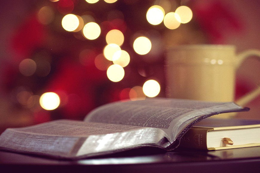 Open Bible with Christmas Lights and Coffee Mug