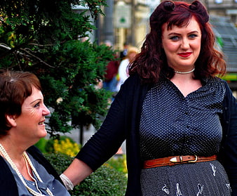 Two women in vintage pin-up style posing outdoors