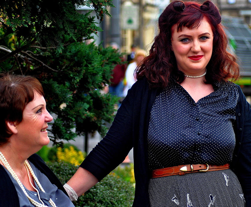 Two women in vintage pin-up style posing outdoors