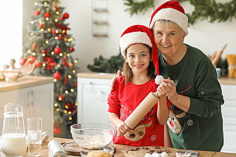Grandmother and granddaughter baking Christmas cookies in kitchen