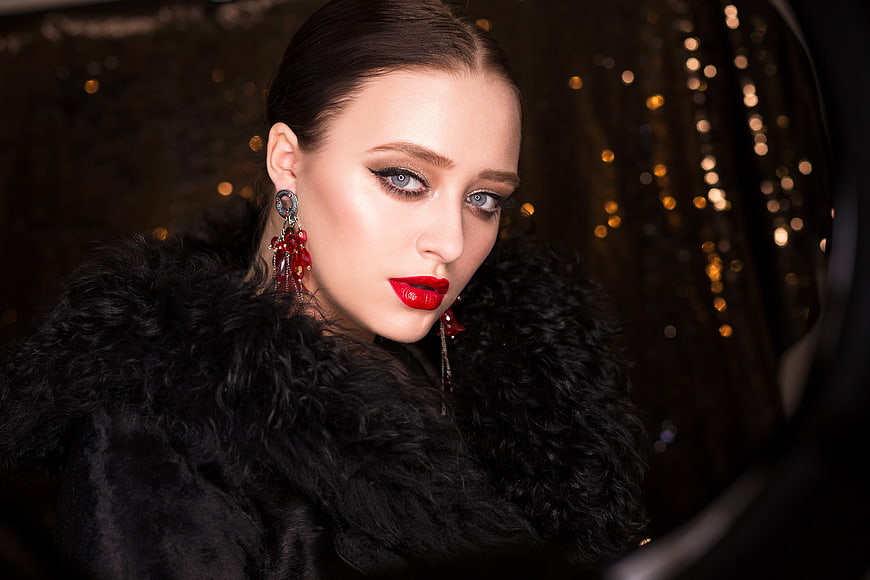 Elegant Woman Portrait Wearing Black Fur Coat and Red Earrings