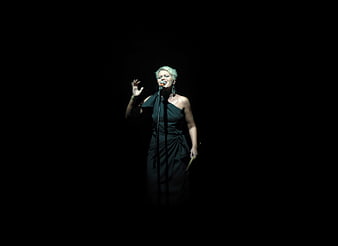 Female Singer Performing on Stage in Spotlight