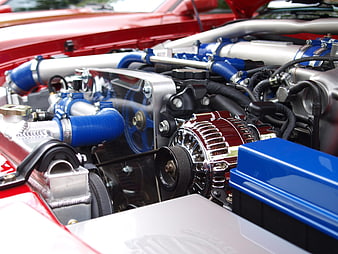 Close-up of a red and blue modified car engine bay