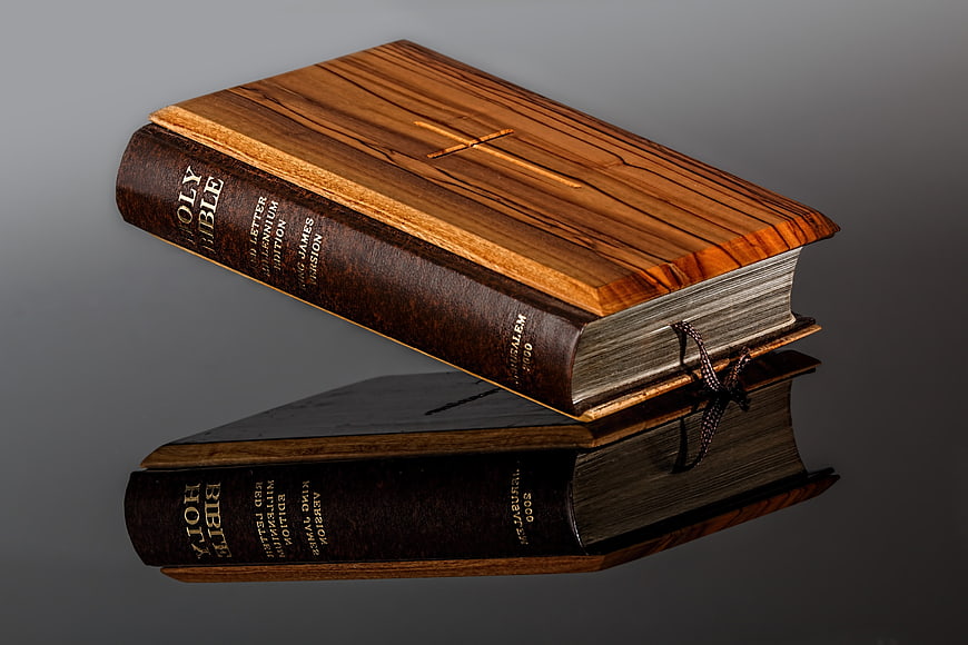 Wooden Holy Bible with Reflection on Dark Background