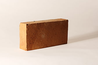 Single Red Brick on White Background