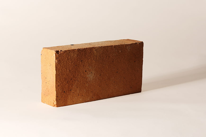 Single Red Brick on White Background
